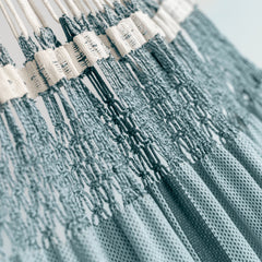 Hand-knotted macramé edge and Fjord blue cotton bed of the Bossanova hammock