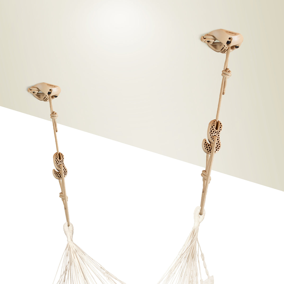 Two beige CasaMount mounts fixed near a wall corner, holding a hammock