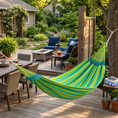 LA SIESTA Brisa Lime double hammock hanging on a wooden deck beside an outdoor dining area
