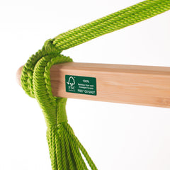 Wooden spreader bar with FSC label and green cords on the Domingo Lime hammock chair