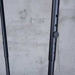Height adjustment holes and knob on the black Fiji stand upright