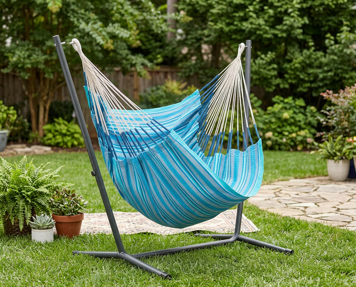 LA SIESTA Cumbia Organic Azure hammock chair on a black chair stand in a garden (stand sold separately)