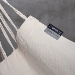LA SIESTA label on the cream Latte organic cotton fabric