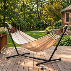 Beige LA SIESTA Modesta Nougat hammock on a black Nautico stand on a wooden deck