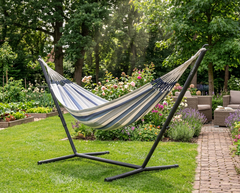 Blue and cream LA SIESTA Brisa Sea Salt hammock on a black Nautico stand in a garden