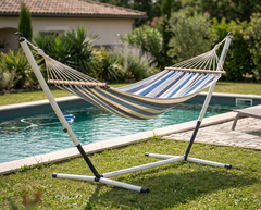 Blue striped LA SIESTA Alisio Sea Salt hammock on a Nautico Cool Grey stand beside a pool