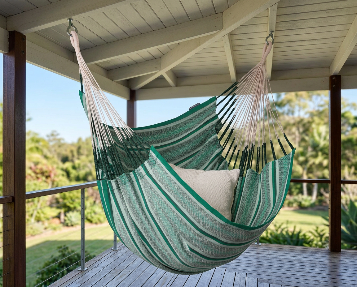 Green LA SIESTA Cumbia Organic Agave hammock chair hanging on a covered porch