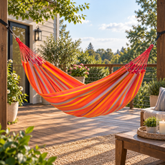 LA SIESTA Brisa Toucan single hammock hanging on a wooden deck beside a house