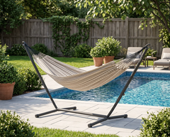 LA SIESTA Flora Zebra kingsize hammock on a black Nautico stand beside a pool