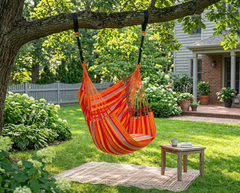 Orange LA SIESTA Cumbia Outdoor Toucan hammock chair hanging from a tree in a backyard