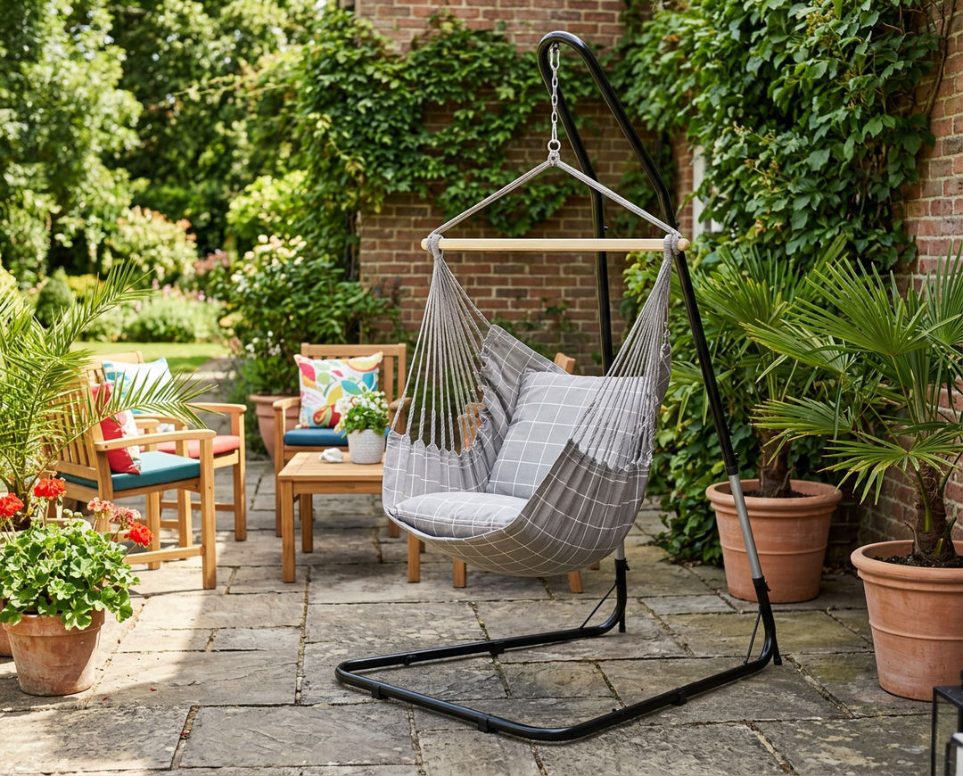 Taupe LA SIESTA Domingo Almond hammock chair on a black stand on a patio (stand sold separately)