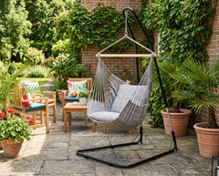 Taupe LA SIESTA Domingo Almond hammock chair on a black stand on a patio (stand sold separately)